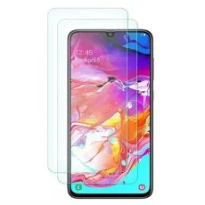Two screen protectors next to a Samsung Galaxy A70s smartphone