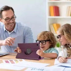 Child using Samsung Galaxy Tab A9 Plus in a purple rotating leather case on a desk, demonstrating hands-free use in an educational setting