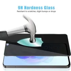 Honor X30i with privacy screen protector partially applied, two spares beside it.