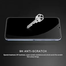A key rests on a phone with a 9H anti-scratch screen protector, highlighting its durability