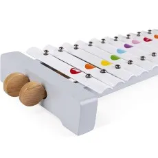 A gray and white toy xylophone with colorful heart shapes on the metal bars, and two wooden mallets attached to the side