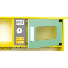 The mint green microwave on a yellow toy kitchen shelf, with the door ajar and the front panel visible.