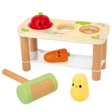 A wooden hammer bench toy with three vegetable-shaped pegs and a mallet