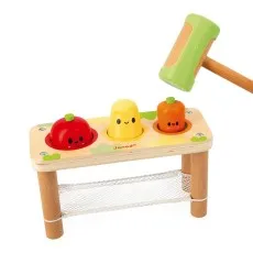A wooden toy with a green mallet and three colorful pegs shaped like a potato, apple, and carrot.