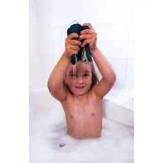 A close-up shot of a dark-haired child holding a smiling octopus bath toy.