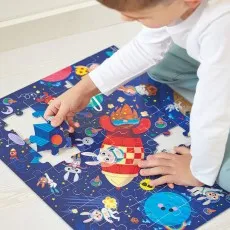 A kid's-eye view of a puzzle being assembled. A piece showing a satellite is being placed into the space scene.