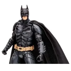 A close-up of a Batman action figure with a gold belt and a black cape