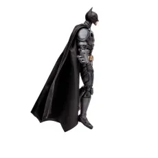 A side view of a Batman action figure in a gliding pose, with its black cape fanned out