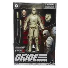 A G.I. Joe action figure of Storm Shadow, from the movie Snake Eyes, is packaged in a box with swords and an alternate head
