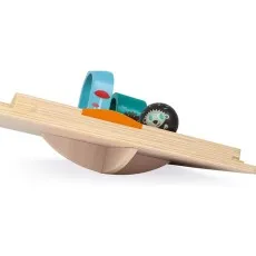 A Janod wooden maze toy is shown from the side, highlighting the rocking base