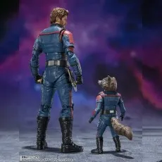 Star-Lord and Rocket Raccoon figures seen from the back, standing in blue uniforms against a purple galaxy backdrop.