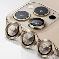 Three gold ring camera lens protectors resting next to a triple-lens gold smartphone camera.