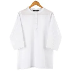 Women’s white eyelet boho blouse with 34 bell sleeves and a button-up front on a wooden hanger..